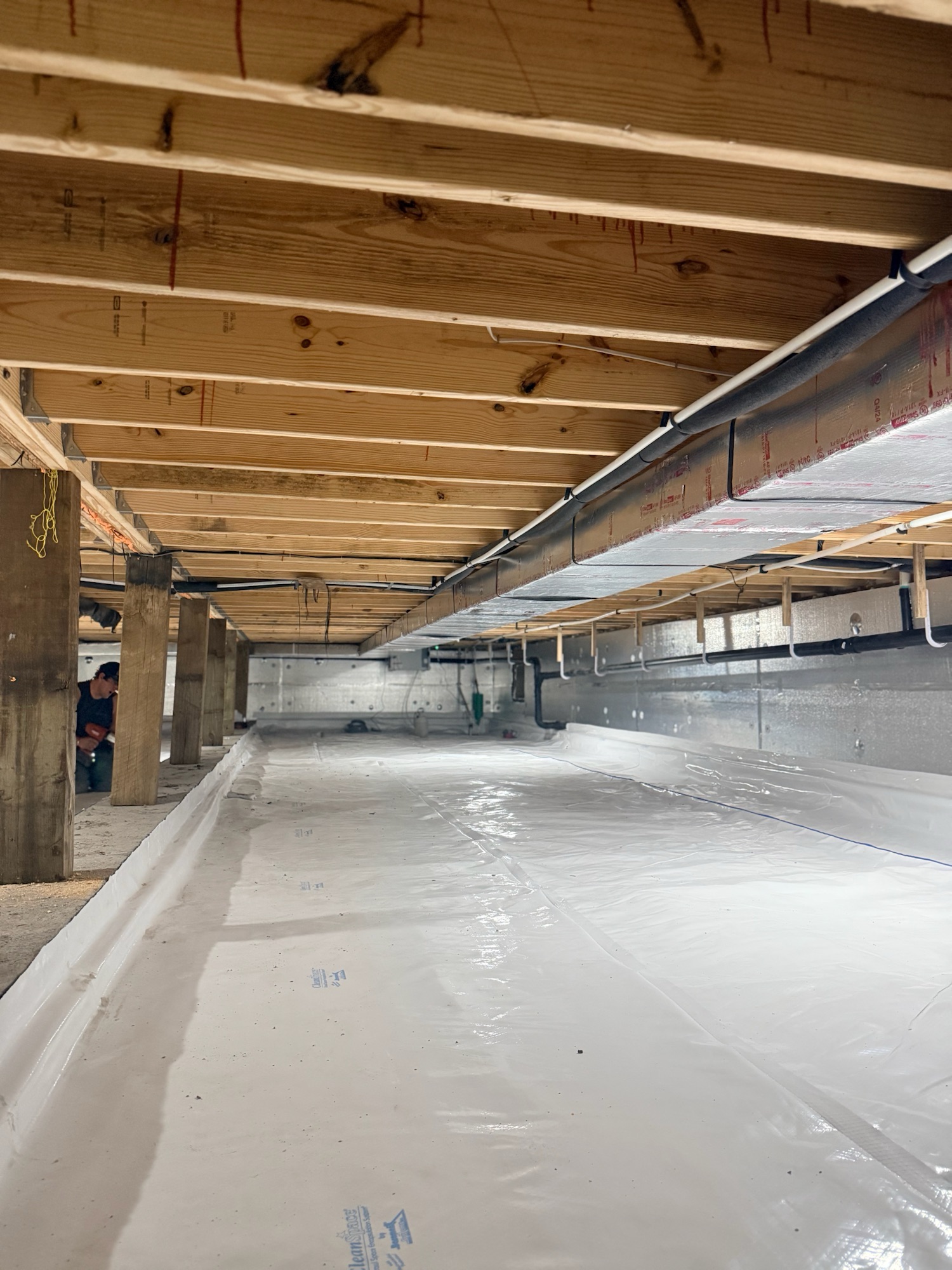Encapsulated crawl space in Reliance, SD with a sealed vapor barrier covering the floor and walls.