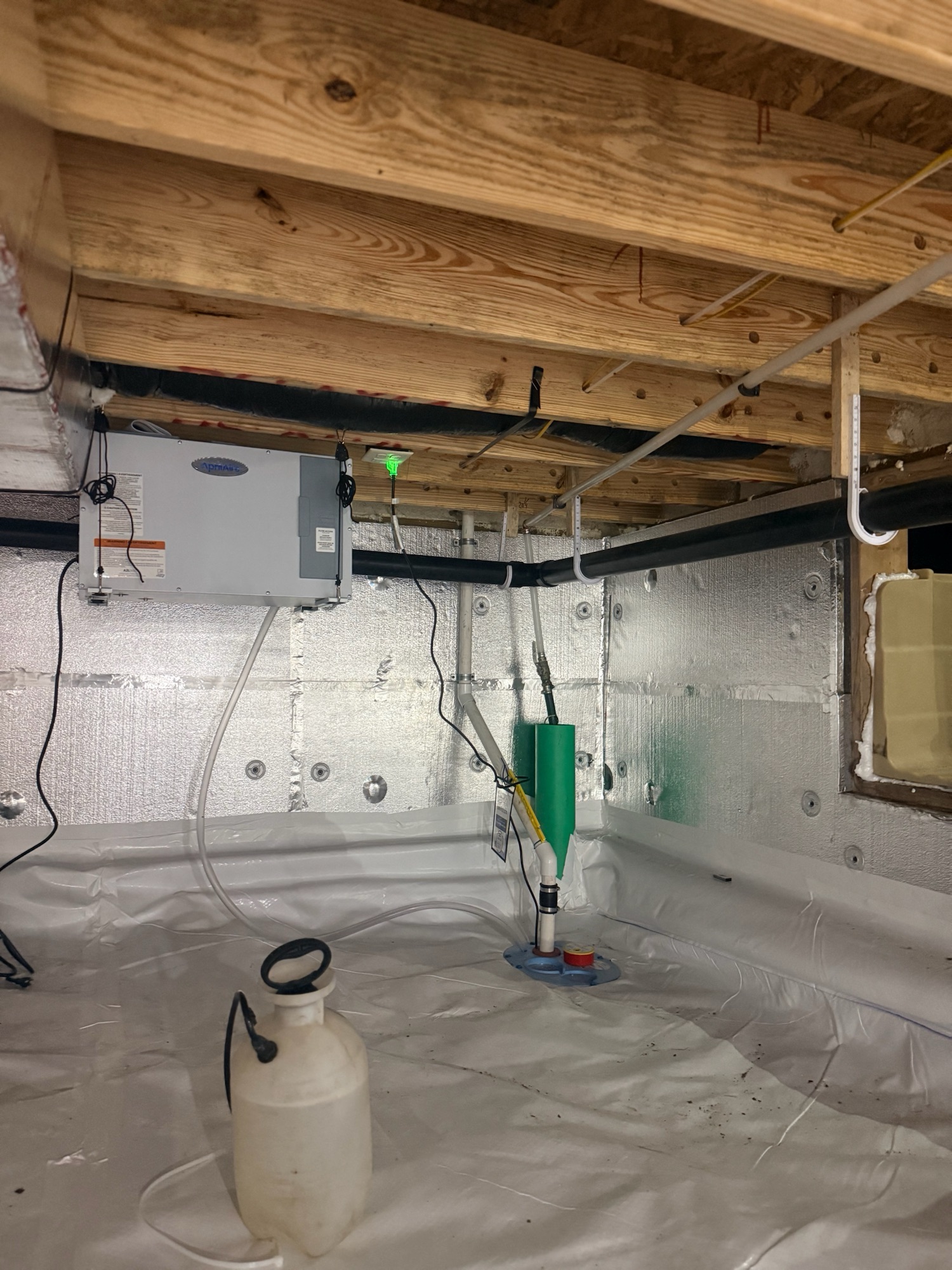 Dehumidifier and sump pump installed in the encapsulated Reliance, SD crawl space for moisture control.