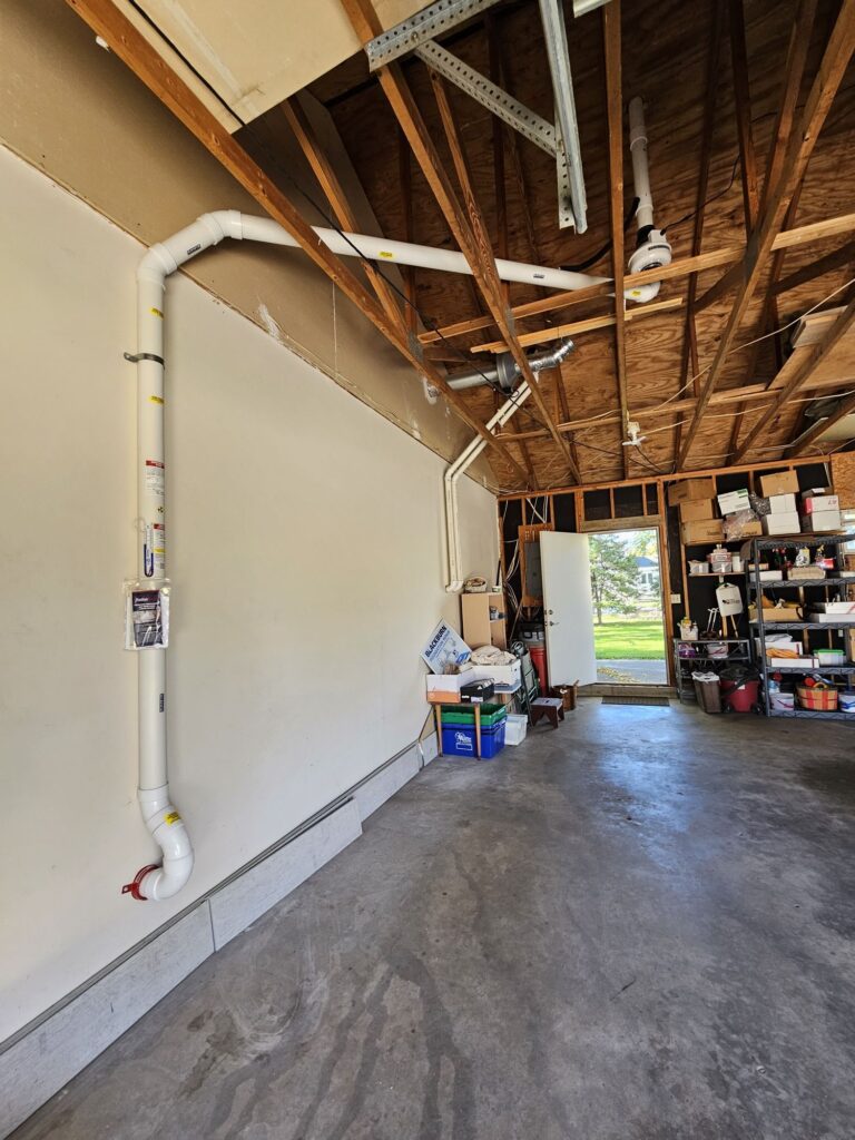 Garage piping for a radon mitigation system installed in a Vermillion, South Dakota home